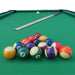 green 7ft pool table with pool balls