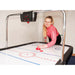 girl playing on air hockey table