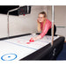 girl playing air hockey table